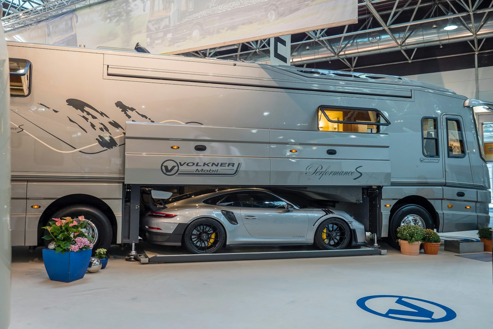 silver sedan parked beside white van